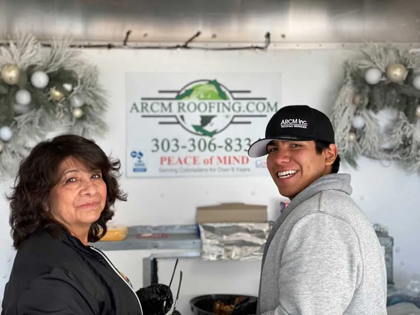 ARCM Cares volunteers inside the ARCM holiday food trailer decorated with wreaths